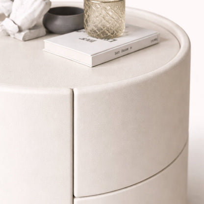 Round white side table with decorative items on top