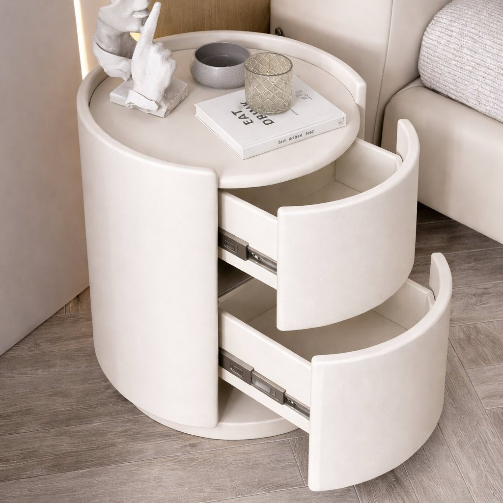 White round side table with drawers in a living room setting