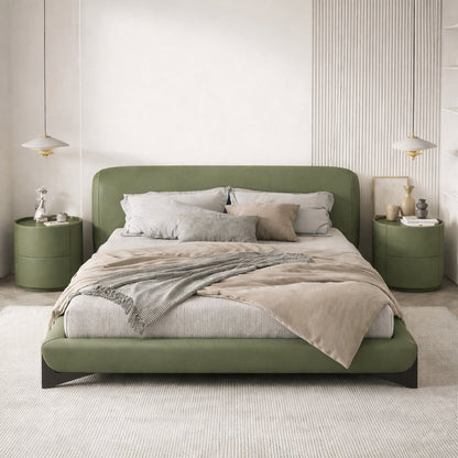 Green bed in a modern bedroom with matching nightstands.