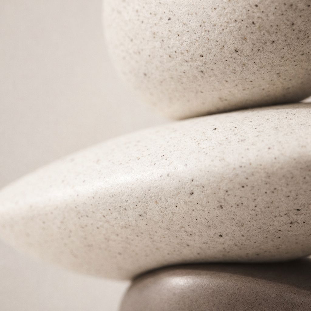 Stack of smooth, beige stones on a light background