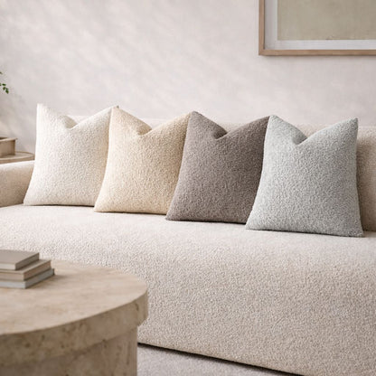 Beige sofa with decorative pillows in a living room setting