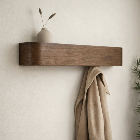 Wooden shelf with a vase and coat on a neutral wall