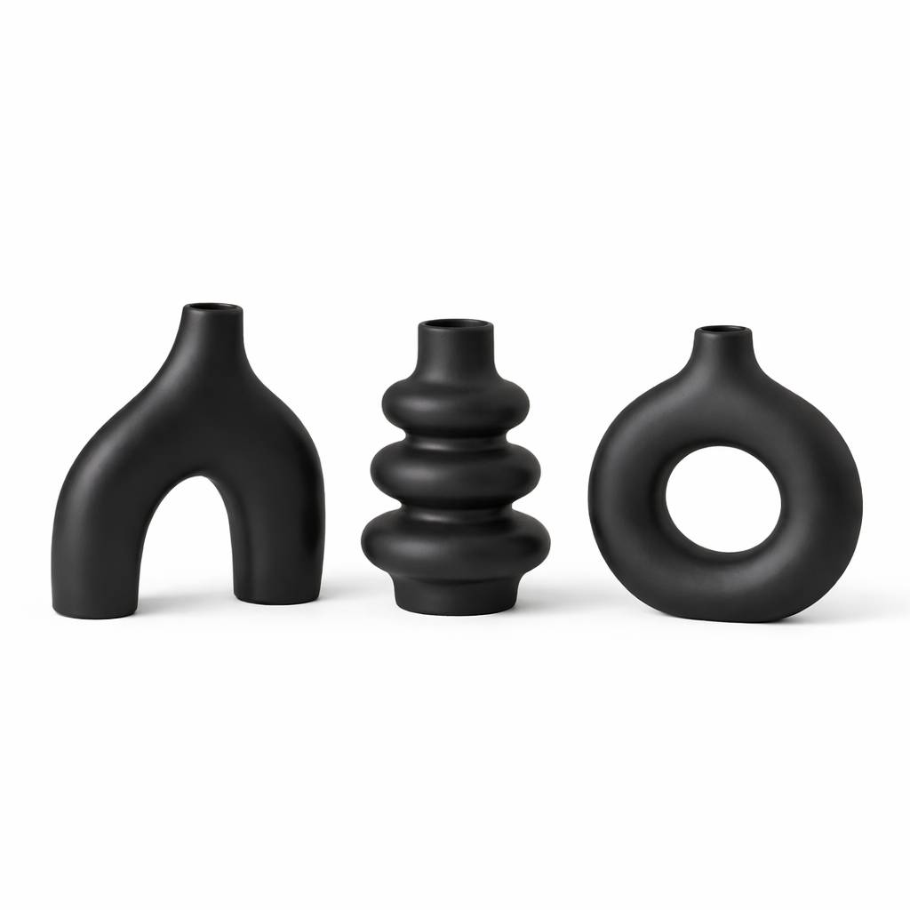 Three black ceramic vases of unique designs on a white background