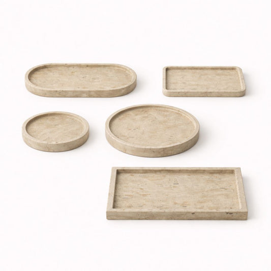 Set of five beige trays of different shapes and sizes on a white background