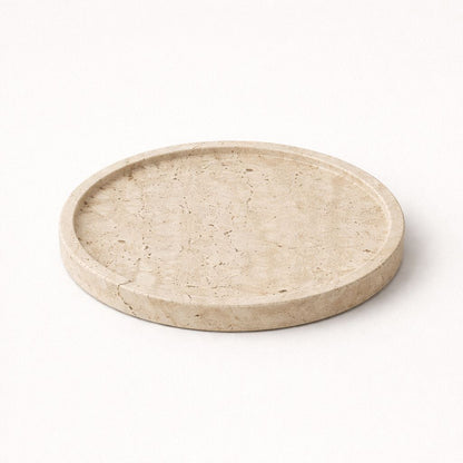 Round beige stone tray on a white background