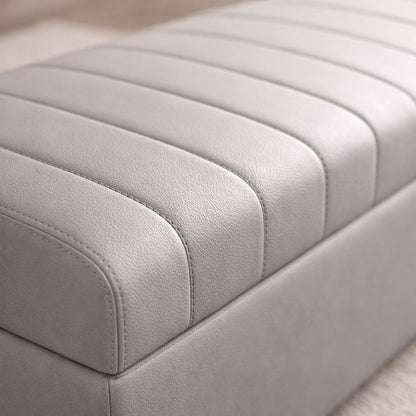 Close-up of a light gray upholstered bench with a ribbed texture.