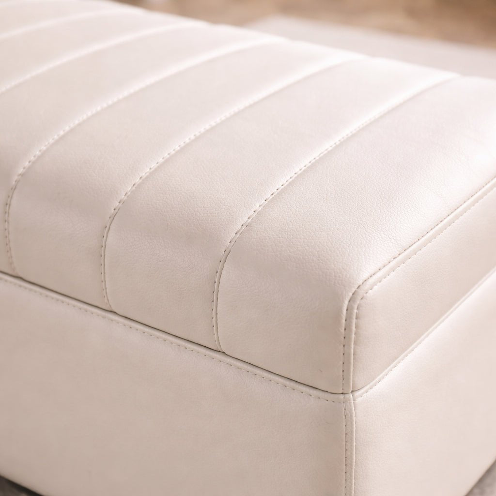 Close-up of a beige ottoman with visible stitching details.